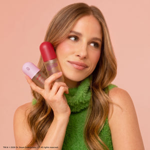 Model holding The Grinch x Kitsch Cindy-Lou Duo Set Cherry Cheer and Whoville Cookies Hair Perfumes