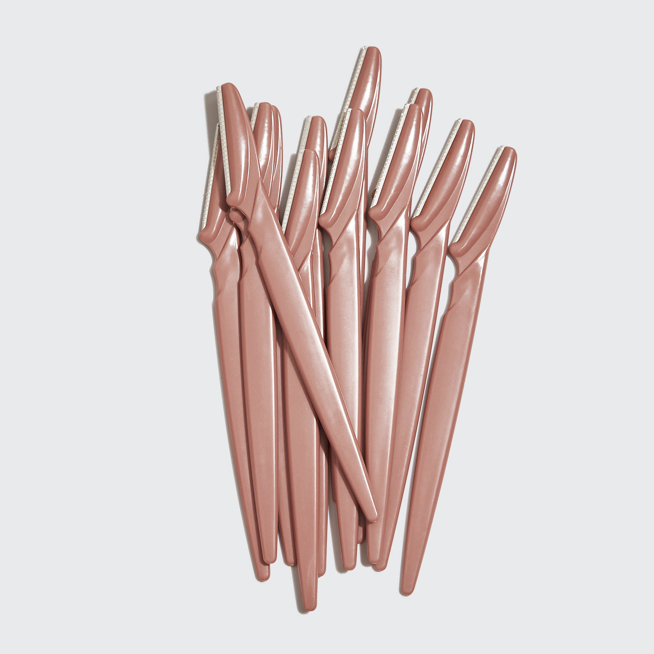 Kitsch Touch Up Dermaplaners 12pc in Terracotta with twelve blades fanned out on a light studio background